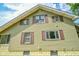 Two-story home with traditional siding, showcasing multiple windows and a foundation with ample light at 4163 Otterbein Ave, Indianapolis, IN 46227