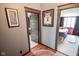 Hallway with views into bedrooms, showcasing neutral wall colors and wood trim at 4163 Otterbein Ave, Indianapolis, IN 46227