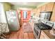 Well-equipped kitchen featuring stainless steel appliances, plentiful cabinetry, and hardwood floors at 4163 Otterbein Ave, Indianapolis, IN 46227
