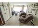 Cozy living room featuring neutral carpeting, a comfortable recliner, and a large window at 4163 Otterbein Ave, Indianapolis, IN 46227