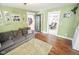 Comfortable living room with a large sofa and hardwood floors at 4163 Otterbein Ave, Indianapolis, IN 46227