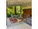 Relaxing patio with a round table, a patterned rug, string lights, comfortable seating, and a hot tub at 4163 Otterbein Ave, Indianapolis, IN 46227