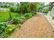 Well-maintained gravel driveway bordered by lush greenery, highlighting the property's outdoor charm at 4163 Otterbein Ave, Indianapolis, IN 46227