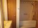 Bathroom featuring a shower-tub combo with a curtain, a cabinet, and tiled walls at 4336 Abby Creek Ln, Indianapolis, IN 46205