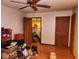 Bedroom with wood floor, ceiling fan, closet and door to another room at 4336 Abby Creek Ln, Indianapolis, IN 46205