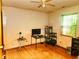 Bedroom features hardwood floors, a window, and a ceiling fan at 4336 Abby Creek Ln, Indianapolis, IN 46205