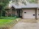 Traditional brick townhome featuring a garage, complemented by a well-maintained yard at 4336 Abby Creek Ln, Indianapolis, IN 46205