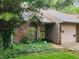 Traditional brick townhome featuring a garage, complemented by a well-maintained yard at 4336 Abby Creek Ln, Indianapolis, IN 46205