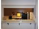 Kitchen pass-through with tile counters and dark wood cabinets at 4336 Abby Creek Ln, Indianapolis, IN 46205