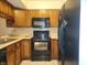 The kitchen boasts a range and microwave oven and warm wood cabinetry at 4336 Abby Creek Ln, Indianapolis, IN 46205