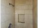Tiled shower featuring shower head and toiletry shelf at 4336 Abby Creek Ln, Indianapolis, IN 46205