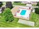 Aerial view of a home with a pool and shuffleboard court, nestled in a well-manicured neighborhood at 4504 Harvard Dr, Anderson, IN 46013