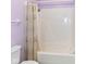 A clean bathroom is adorned with a purple color scheme with shower and white toilet at 4504 Harvard Dr, Anderson, IN 46013