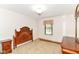 Neutral bedroom with wooden furniture, large window, and carpet floors at 4504 Harvard Dr, Anderson, IN 46013