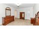 Spacious bedroom with neutral carpet, wooden furniture and ensuite bathroom at 4504 Harvard Dr, Anderson, IN 46013