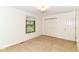 A bright bedroom offers a closet, window, light-colored carpet, and neutral walls at 4504 Harvard Dr, Anderson, IN 46013