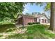 Exterior view with brick accents, lush lawn, and the convenience of an attached garage at 4504 Harvard Dr, Anderson, IN 46013