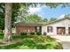 Side exterior featuring brick accent, vinyl siding, a well-kept lawn, and an attached garage at 4504 Harvard Dr, Anderson, IN 46013