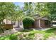 A charming home boasts brick and vinyl siding, lush landscaping, and a well-maintained lawn at 4504 Harvard Dr, Anderson, IN 46013