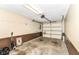 Spacious garage with concrete floor, automatic door opener, and ample storage space at 4504 Harvard Dr, Anderson, IN 46013