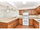 Updated kitchen with stainless appliances, wood cabinets, and granite countertops at 4504 Harvard Dr, Anderson, IN 46013