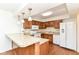 Well-equipped kitchen featuring white appliances, granite countertops, and a convenient breakfast bar at 4504 Harvard Dr, Anderson, IN 46013