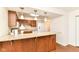Open kitchen features wood cabinets, granite counters and bar area, and updated appliances at 4504 Harvard Dr, Anderson, IN 46013