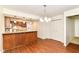 Open kitchen with granite countertops, breakfast bar, and laminate floors for a modern living style at 4504 Harvard Dr, Anderson, IN 46013