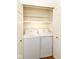 Convenient laundry closet includes washer, dryer, and storage shelves at 4504 Harvard Dr, Anderson, IN 46013
