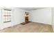 Spacious living room with neutral carpeting, natural light, and a view into the adjacent kitchen area at 4504 Harvard Dr, Anderson, IN 46013