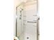 A modern shower features glass doors, a handheld shower head, grab bar, and built-in shelving for toiletries at 4504 Harvard Dr, Anderson, IN 46013
