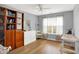 Bright bedroom with large window, hardwood floors, cabinet and work space at 482 Sycamore St, Brownsburg, IN 46112