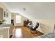 Cozy upstairs bedroom featuring hardwood floors and comfortable seating at 482 Sycamore St, Brownsburg, IN 46112