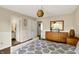 Light-filled bedroom featuring a wooden dresser with mirror, neutral walls and a decorative light fixture at 482 Sycamore St, Brownsburg, IN 46112