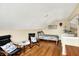 Upstairs bedroom with sloped ceilings, hardwood floors, and comfortable seating at 482 Sycamore St, Brownsburg, IN 46112