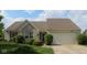 Charming one-story home with a two-car garage, lush landscaping, and a brick facade at 482 Sycamore St, Brownsburg, IN 46112