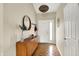 Inviting foyer with wood flooring, a stylish mirror, and a decorative pendant light at 482 Sycamore St, Brownsburg, IN 46112