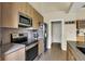 Modern kitchen with stainless steel appliances, sleek cabinets, and granite countertops at 482 Sycamore St, Brownsburg, IN 46112