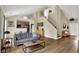 Open concept living area with hardwood floors and seamlessly connected to the kitchen at 482 Sycamore St, Brownsburg, IN 46112