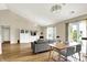 Bright living area with hardwood floors, vaulted ceilings, and access to an outdoor patio at 482 Sycamore St, Brownsburg, IN 46112