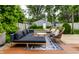 Inviting backyard with stylish furniture, a fire pit, a wooden deck, and lush greenery at 5015 N Park Ave, Indianapolis, IN 46205