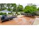 Spacious backyard features a wooden deck with stylish outdoor furniture and lush greenery at 5015 N Park Ave, Indianapolis, IN 46205
