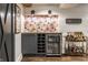 Basement bar featuring a wine rack, beverage refrigerator, and display shelving at 5015 N Park Ave, Indianapolis, IN 46205
