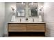 Bathroom boasts double sinks with elegant faucets, ample lighting, and decorative mirrors at 5015 N Park Ave, Indianapolis, IN 46205