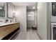 Stylish bathroom featuring a double sink vanity, decorative tile, and a glass-enclosed shower at 5015 N Park Ave, Indianapolis, IN 46205