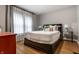 Inviting bedroom with a comfortable bed, stylish lamps, and a window with decorative curtains at 5015 N Park Ave, Indianapolis, IN 46205