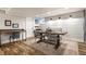 Dining area with desk, farmhouse table, modern chairs, and ample lighting at 5015 N Park Ave, Indianapolis, IN 46205