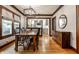 Dining room with a wooden table, hardwood floors, and seamless access to the kitchen at 5015 N Park Ave, Indianapolis, IN 46205