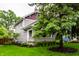 Side angle view of a well-kept home with mature trees and lush lawn at 5015 N Park Ave, Indianapolis, IN 46205