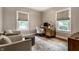 Home office with lots of light from large windows, comfortable seating, and a writing desk at 5015 N Park Ave, Indianapolis, IN 46205